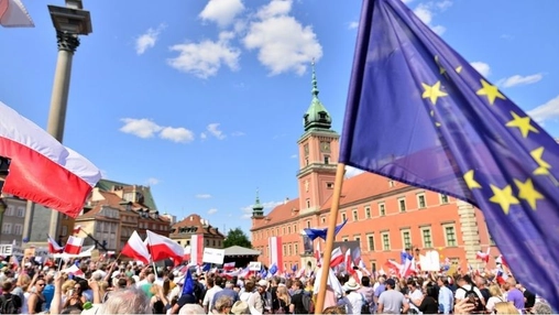 European Union and Polish flags raised during public demonstration in Warsaw