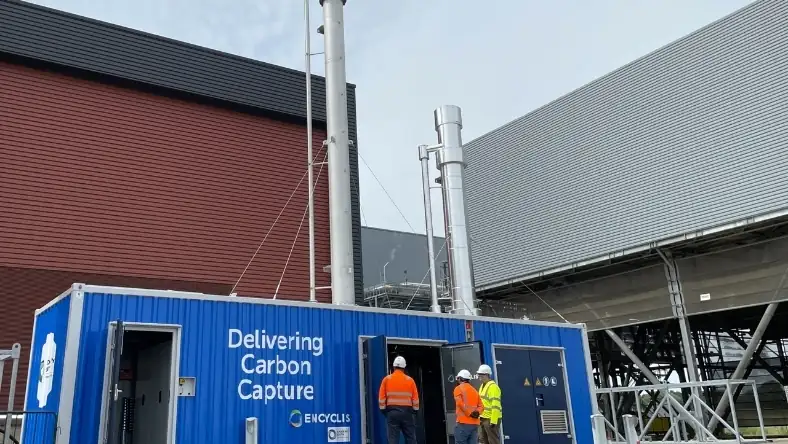 Carbon capture equipment housed in a blue container at an industrial facility