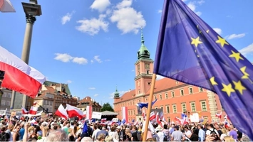 European Union and Polish flags raised during public demonstration in Warsaw
