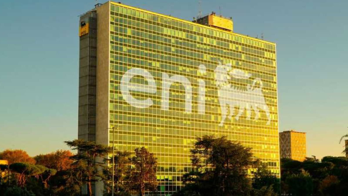 Eni headquarters building reflecting sunset with Eni logo visible
