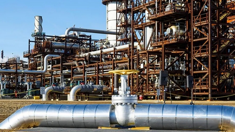 Industrial facility with large steel pipelines and processing infrastructure